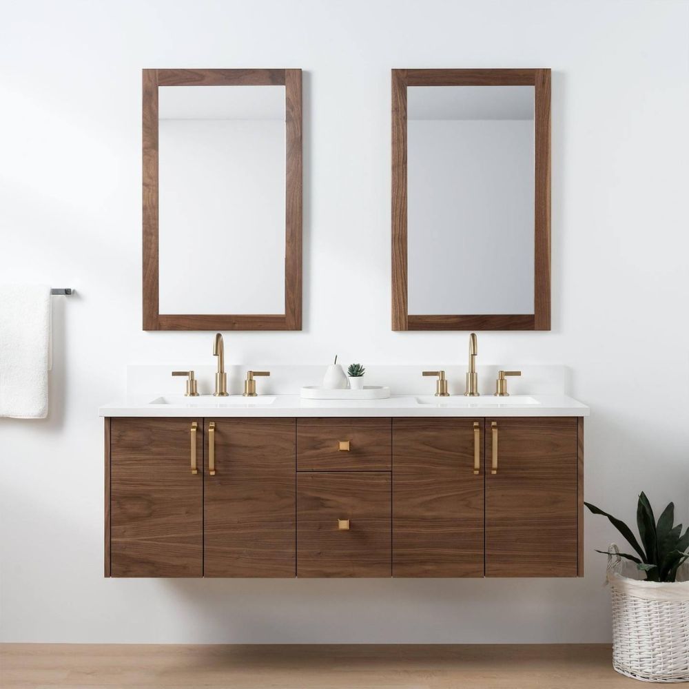 Bathroom vanity with wooden cabinets, mirrors, and brass fixtures on a white wall.