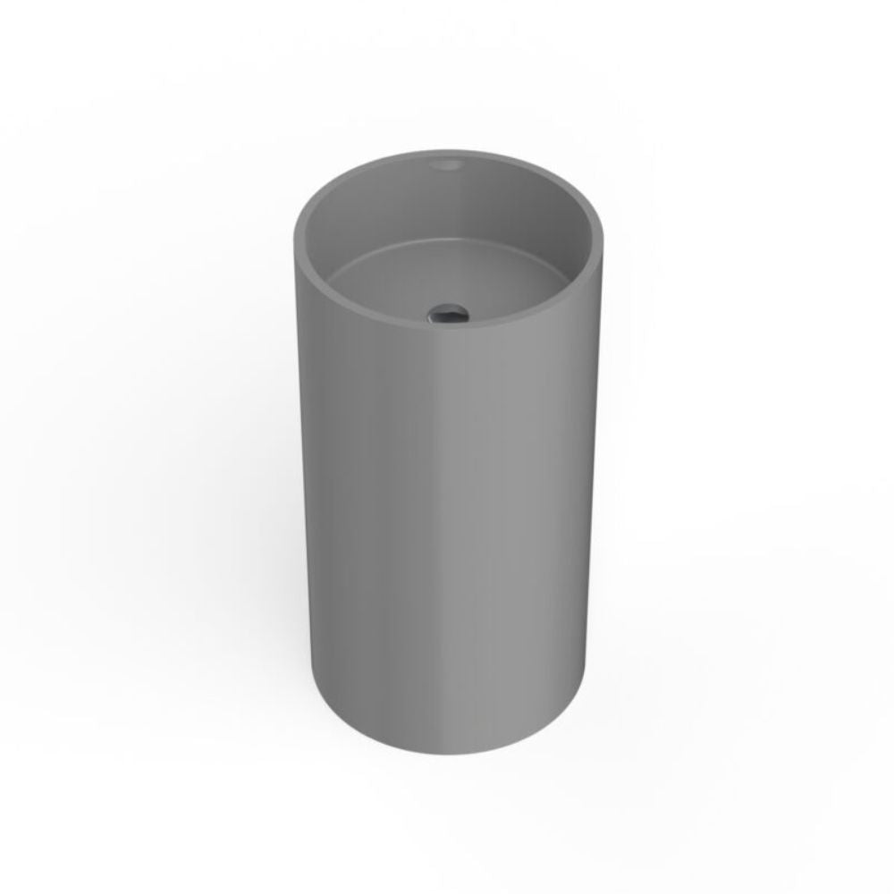 A minimalist gray cylindrical pedestal sink with a smooth matte finish and a small drain hole at the top, shown on a clean white background.