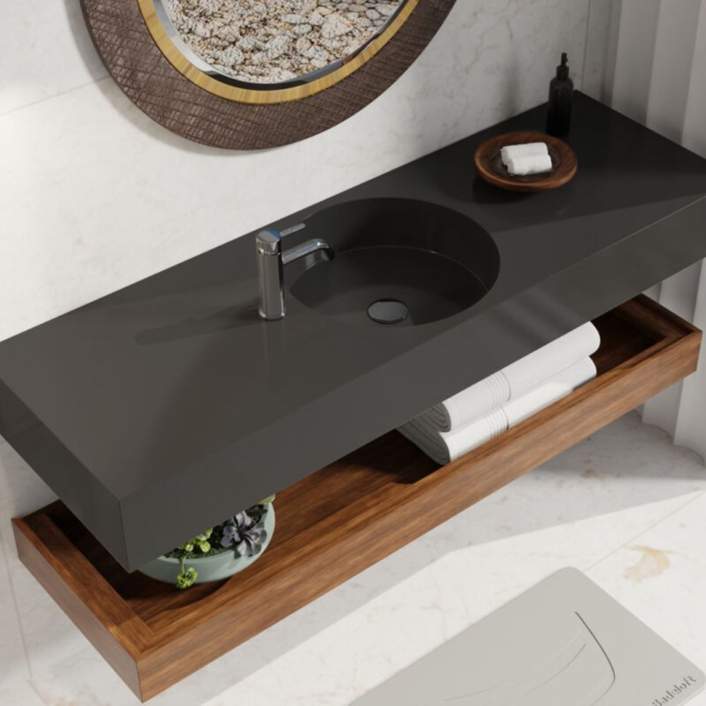 Bathroom vanity with black sink and wooden shelf, featuring a mirror and toiletries.