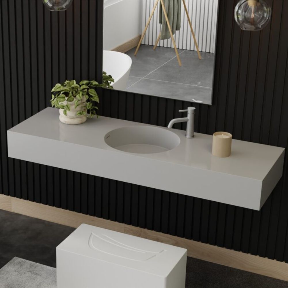 Modern bathroom vanity with sink, mirror, and decorative items.