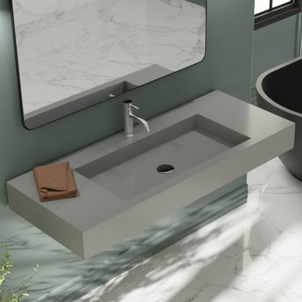 Modern bathroom sink with faucet and towel, featuring a large mirror.