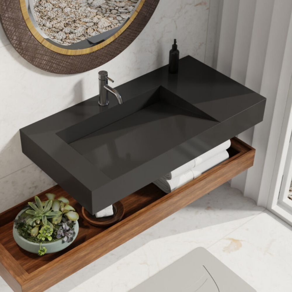 Bathroom vanity with black sink and wooden shelf, featuring a plant and toiletries.