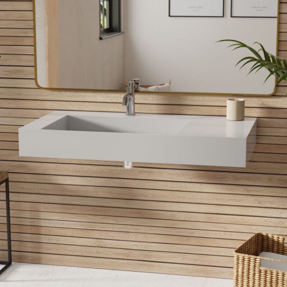 Bathroom vanity with white sink against a wooden wall