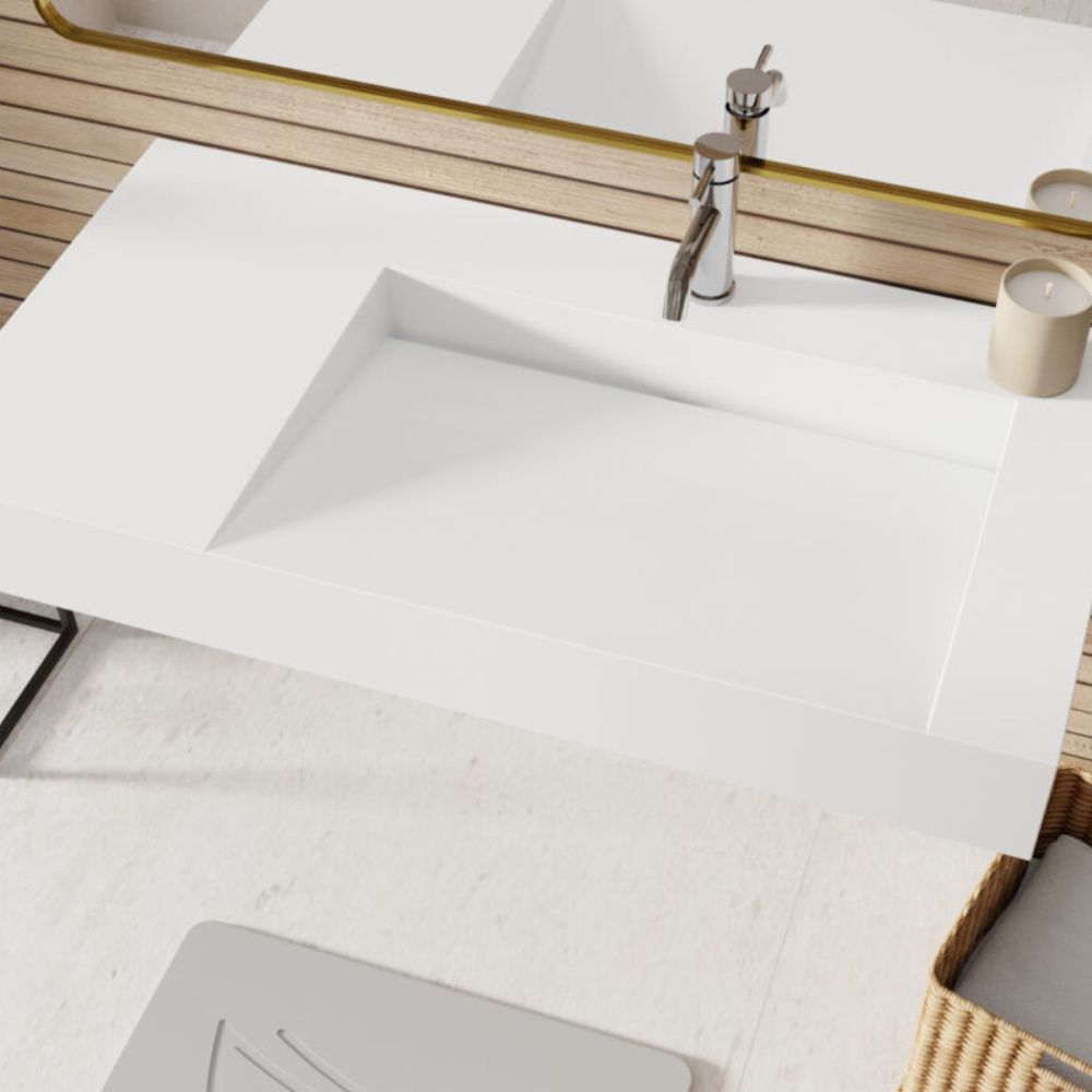 White sink with wooden cabinet and mirror in a bathroom setting