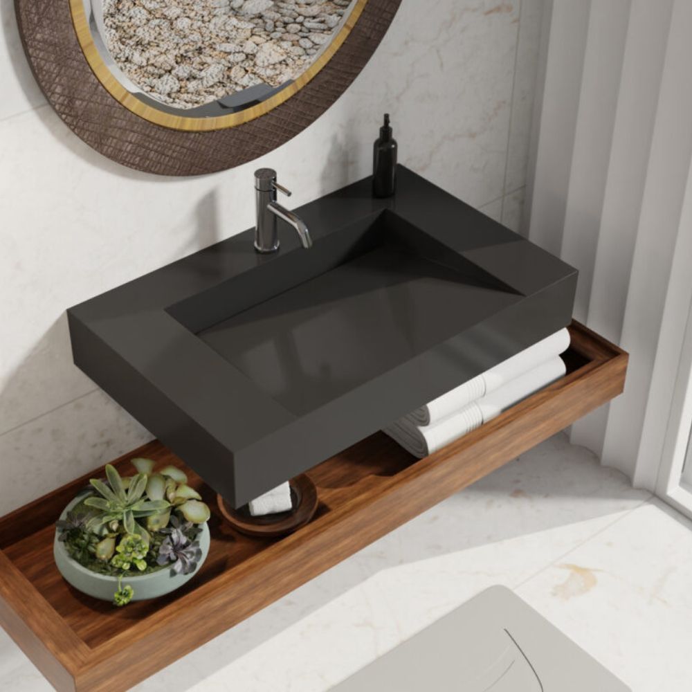 Bathroom vanity with black sink and wooden shelf, featuring a mirror and decorative elements.