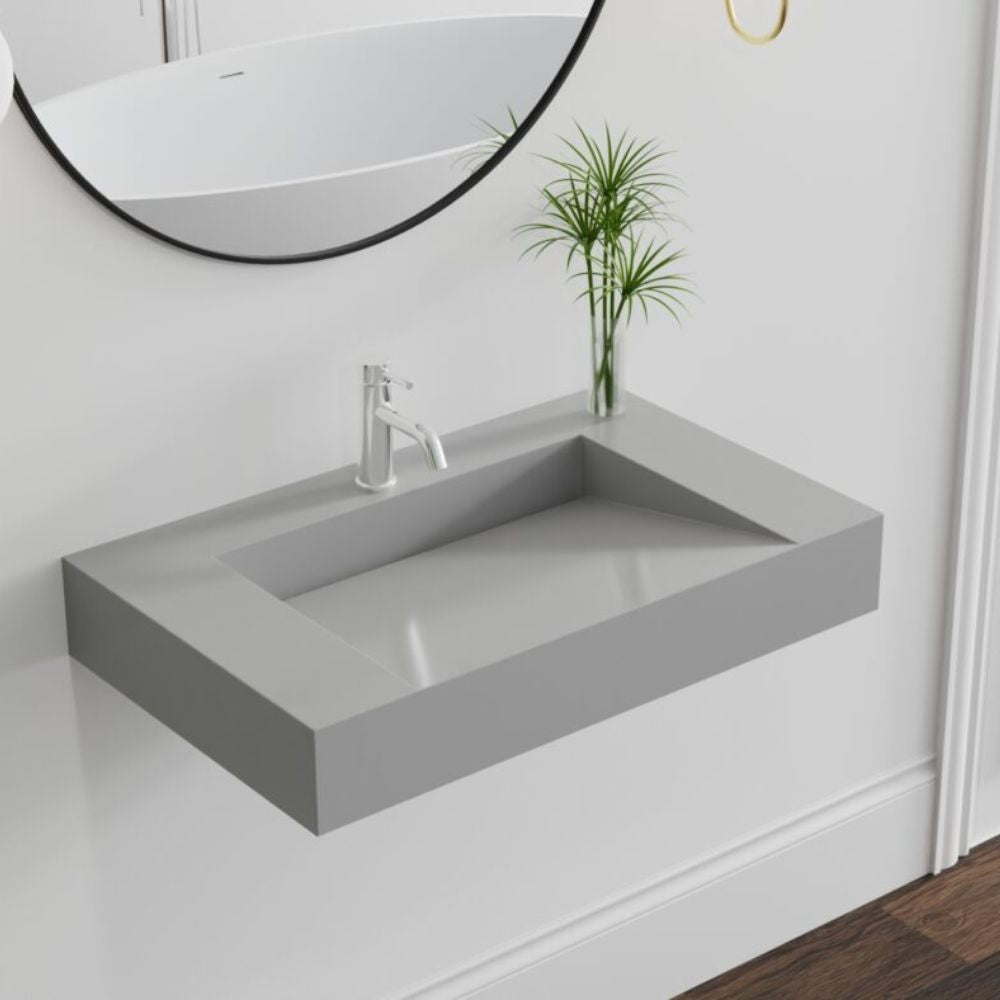 Gray concrete sink with silver faucet in a bathroom setting