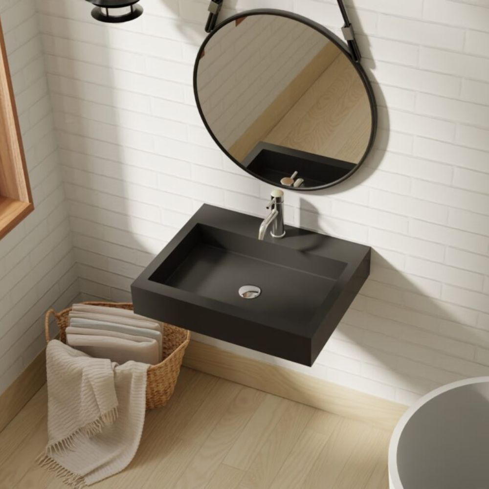 Black sink with round mirror in a bathroom setting