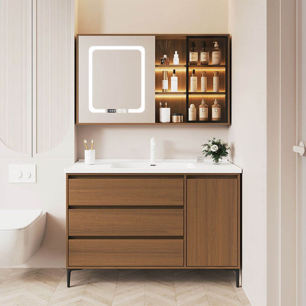 Bathroom vanity with wooden cabinet, white countertop, and illuminated mirror.